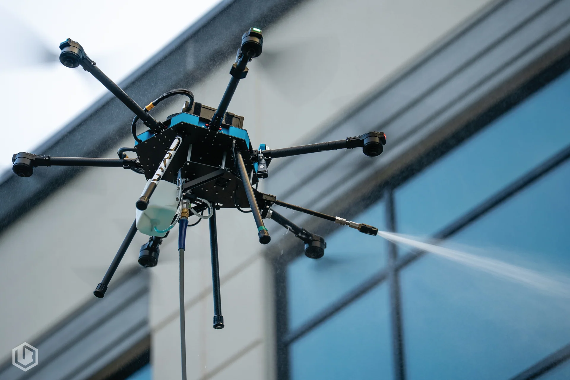 Cleaning drone working alongside a commercial building